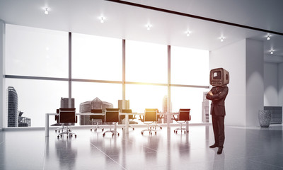 Businessman with an old TV instead of head.
