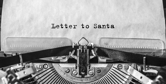 Letter to Santa printed on an old vintage typewriter, close-up. Letter to Santa Claus with wishes for gifts, Christmas, New Year.