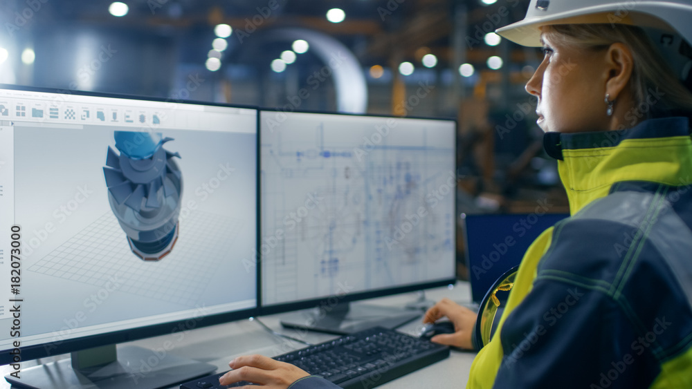 Poster inside the heavy industry factory female industrial engineer works on the personal computer on the t