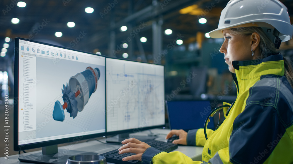 Poster inside the heavy industry factory female industrial engineer works on the personal computer on the t