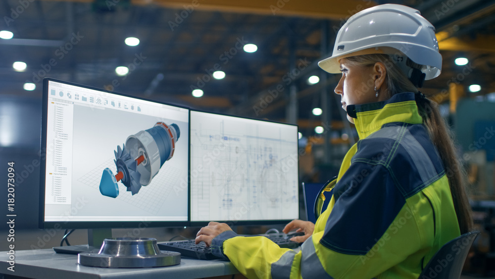 Poster inside the heavy industry factory female industrial engineer works on the personal computer on the t