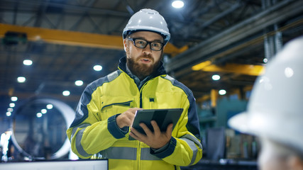 Inside the Heavy Industry Factory Female Industrial Engineer Works on Personal Computer She Designs...