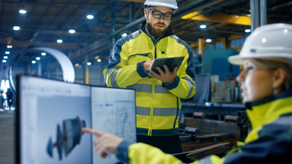 Inside the Heavy Industry Factory Female Industrial Engineer Works on Personal Computer She Designs...