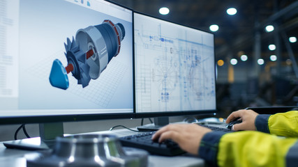 Inside the Heavy Industry Factory Close-up Footage of  Industrial Engineer's Hands Working on the Personal Computer with Two Monitors Designing Turbine/ Engine in 3D, Using CAD Program. - obrazy, fototapety, plakaty