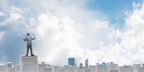 Businessman standing with megaphone.