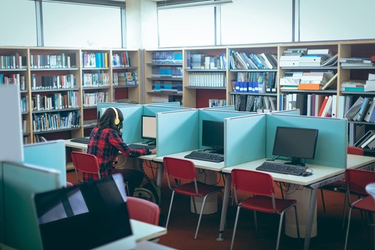 Girl using computer in library
