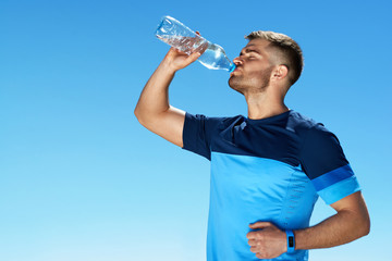Man Drinking Water After Running. Portrait.