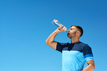 Man Drinking Water After Running. Portrait.