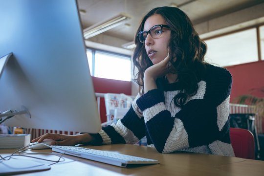 Girl using computer in library