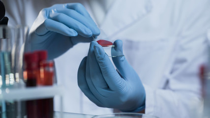 Medical scientist going to conduct laboratory research on blood sample, clinic