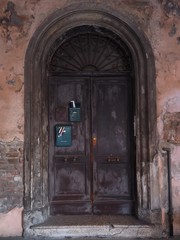 Italian old door with mail boxes.