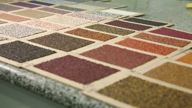 Sample color of roofing material. Different colors of roof covering. Large palette of colors of roofing material. Sample of the color of the roofing felt is laid out on the table. Selective focus.