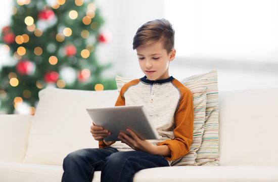 boy with tablet pc at home at christmas