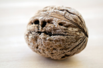 Walnut kernels and whole walnuts on rustic old wooden table