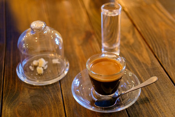 espresso coffee in transparent cup on a wooden table