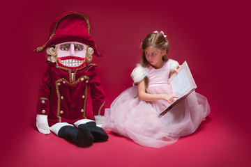 The beauty ballerina sitting with nutcracker