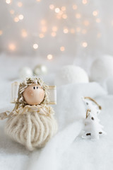 Christmas tree ornaments on a snow surface with christmas lights in the background. Christmas...