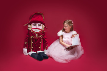 The beauty ballerina sitting with nutcracker