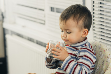 Portrait of a boy drinking a glass of water