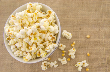 Fresh, delicious hand-popping popcorn in a bowl on a rustic jute base