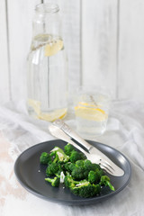 Broccoli cooked with garlic, ginger and sesame served with lemonade. Rustic style.