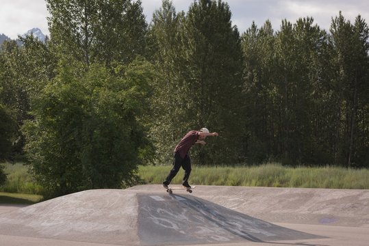 Man skating on skateboard in skate park