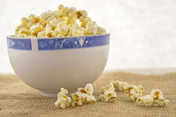 Fresh, delicious hand-popping popcorn in a bowl on a rustic jute base