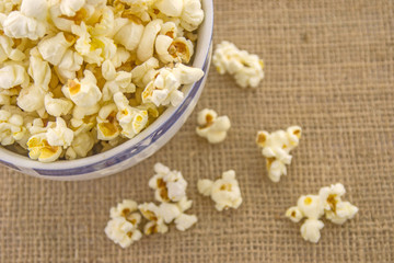 Fresh, delicious hand-popping popcorn in a bowl on a rustic jute base