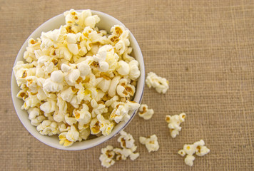 Fresh, delicious hand-popping popcorn in a bowl on a rustic jute base