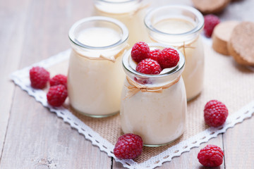 Jars with yogurt and raspberries
