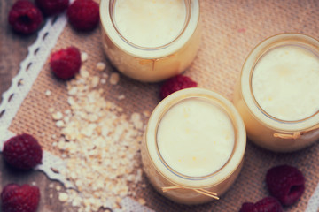 Jars with yogurt, raspberries and oat flakes 