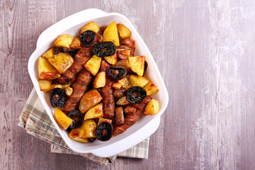 Sausages, potato and mushroom bake in a tin