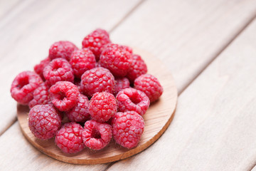 Raspberries on a wooden cutting board