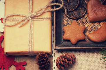 Gift box, gingerbread cookies, fir tree branch, handmade snowflake 