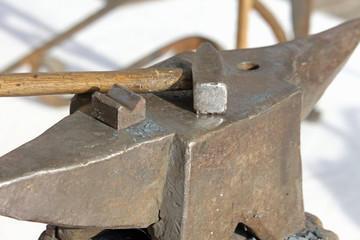 big anvil and hammer in the workshop of blacksmith