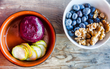 Pickled Beetroot and Cucumber Blueberries and walnuts in a dish.