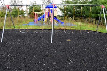 Fototapeta premium Empty abandoned playground with weeds and decay
