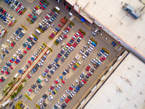 Aerial view of parking lot with cars. Industrial background on transportation theme. 