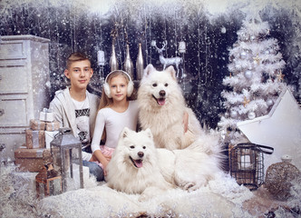 Girl and boy with two white dog