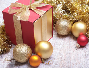 Gift boxes with many christmas balls on wood background