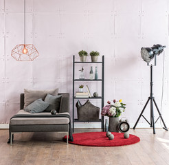 modern living room corner sofa behind stone soft wall and black lamp