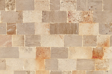 Seamless pattern of aged castle wall stone texture in the Greek city of Lindos