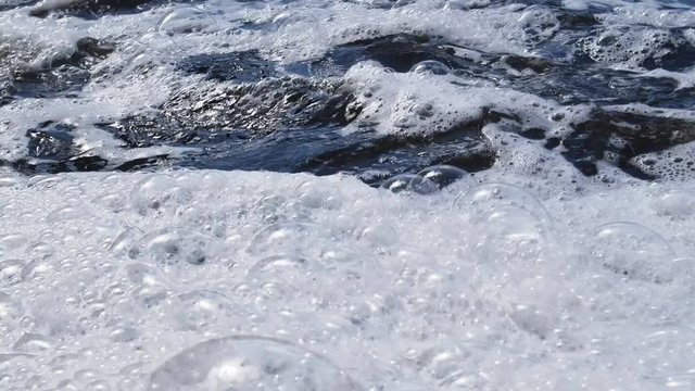 River foam with huge bubbles as consequence of water pollution synthetic detergents (soapless soap)

