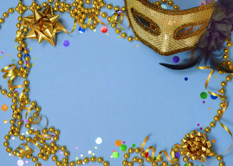 A party border great for New Year's Eve in gold and black with colorful confetti, a mask, beads and bows on a blue background. Vintage filter applied