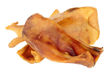 Group of dried pigs ears dog chew treats isolated on a white background