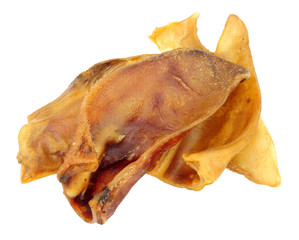 Group of dried pigs ears dog chew treats isolated on a white background