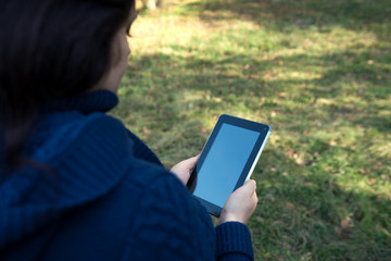 the girl is holding a tablet