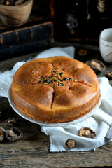 Snack cake with chicken, mushrooms, eggplant, onion and Provence herbs on an old wooden background. Rustic style.