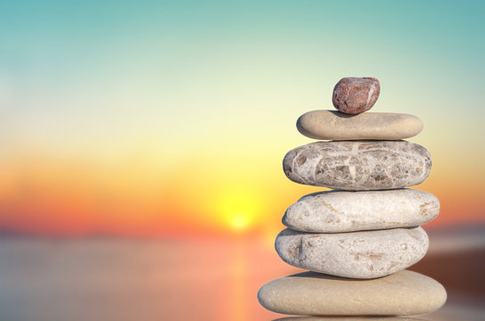 Several pebble stone isolated on sundown complex like symbol for zen and relax concept