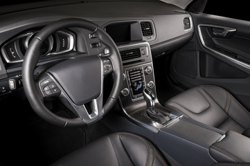 Fototapeta na wymiar Luxury car inside. Interior of prestige modern car. Comfortable leather seats. Black perforated leather cockpit